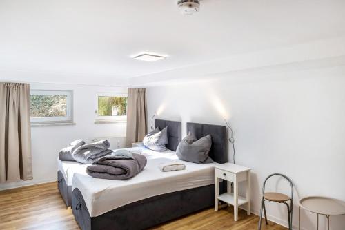 a bedroom with a bed with blankets on it at Haus am Eschenbach in Lindenberg