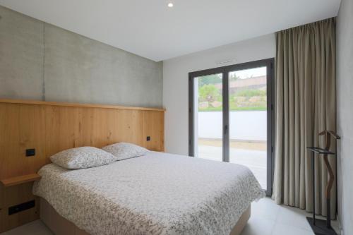 a bedroom with a bed and a large window at Villa Ker Marie in Locquirec
