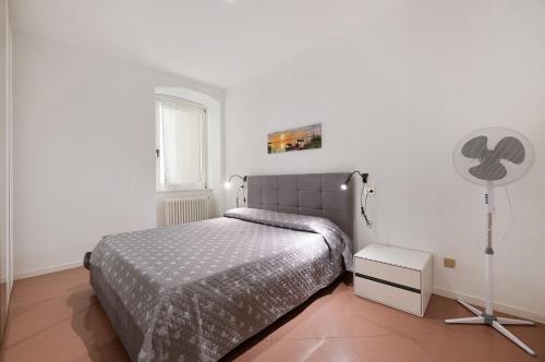 a bedroom with a bed and a fan at Lake view Domaso in Domaso