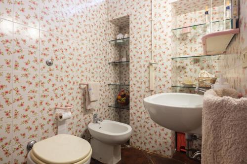 a bathroom with a toilet and a sink at Gli Archi with pool - Lecce in Lecce