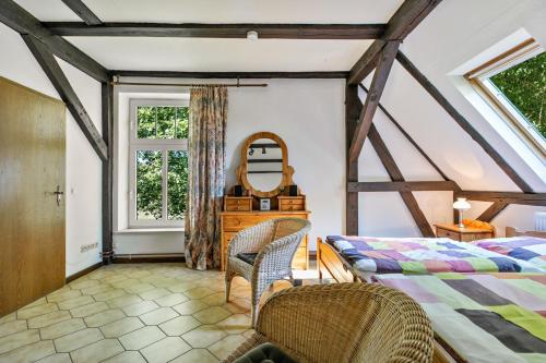 a bedroom with a bed and a mirror and a window at Ferienhof Schülp in Schülp