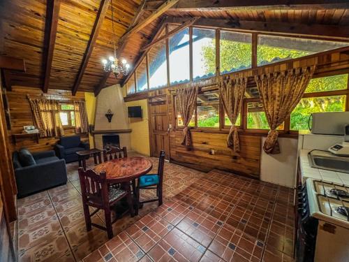 a kitchen and living room with a table in a house at La Huerta in Mazamitla