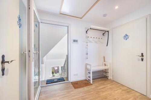 a hallway with a sliding glass door and a staircase at Ferienwohnung Stella Maris in Carrenzien