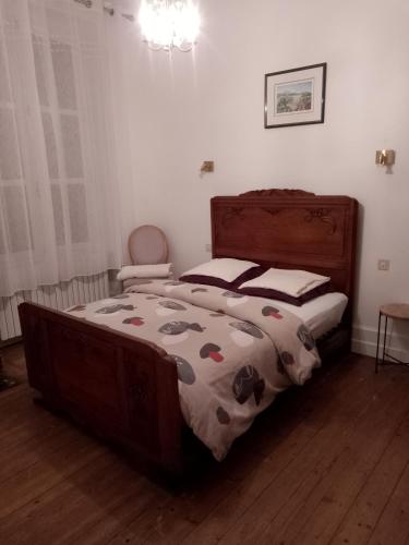 a bedroom with a bed with a blanket on it at BB des 6 arcs"" in Coulonces