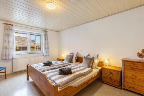 a bedroom with a bed with two bags on it at Ferienwohnung Schönhals in Herbstein