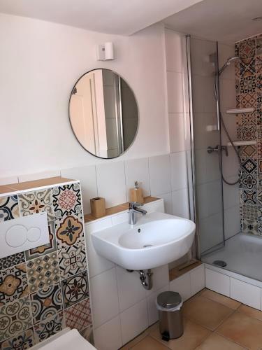 a bathroom with a sink and a mirror at Mein Ferienhaus Rosenbusch 2 in Kemmern