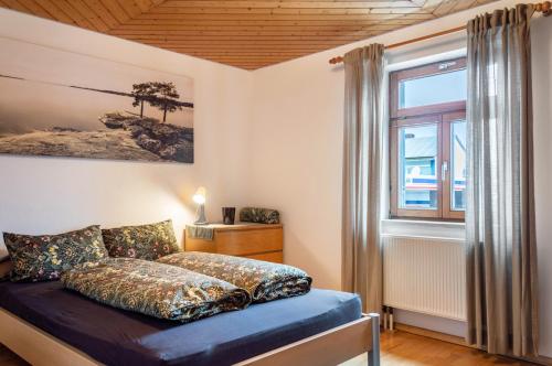 a bedroom with a bed and a window at Ferienwohnung mit privater Sauna in Gunzenhausen