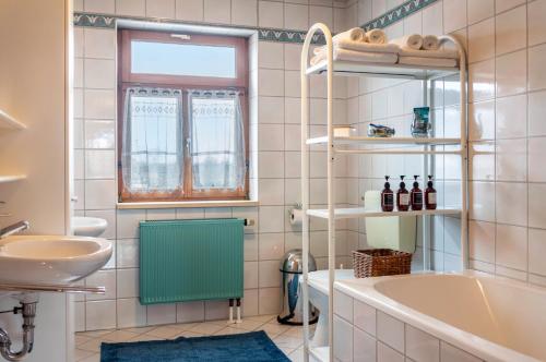 a bathroom with a tub and a sink at Ferienwohnung mit privater Sauna in Gunzenhausen