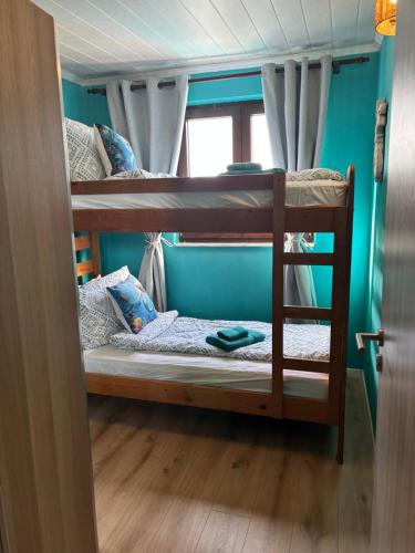 two bunk beds in a room with a window at Mermaid Cove in Sukošan