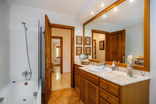 a bathroom with a sink and a shower and a tub at Can Gual Inca in Inca