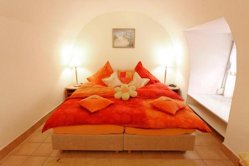 a bedroom with a red bed with a flower on it at Ferienwohnung Mengeler in Freiburg im Breisgau