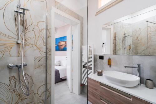 a bathroom with a sink and a mirror at Luxury 12 in Tuglie