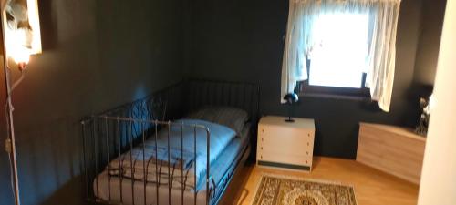 a small bedroom with a bed and a window at Käfer D in Waldbrunn