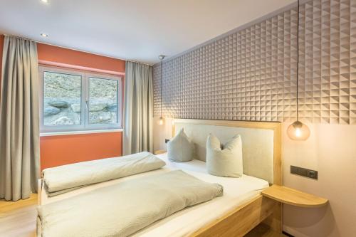 a bedroom with a bed and a window at Luisalle Top 2 in Auffach