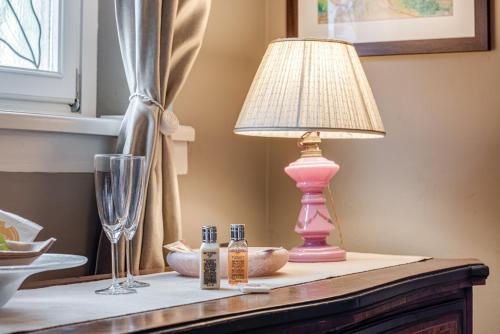 a pink lamp sitting on top of a table at Pretty Suite Firenze Fiesole in Florence