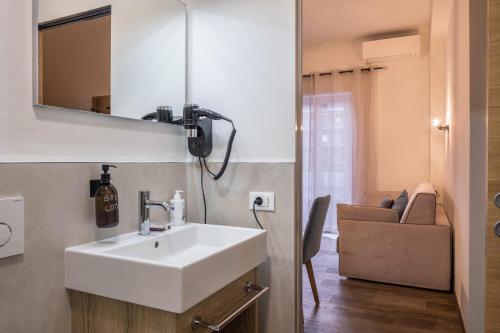 a bathroom with a white sink and a mirror at Apartment Annabel in Bolzano