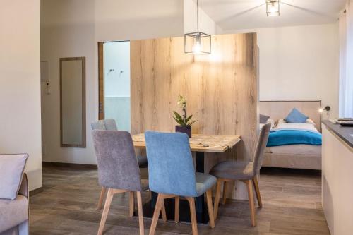 a dining room with a table and chairs and a bed at Apartment Annabel in Bolzano