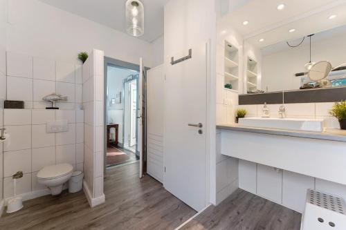 a bathroom with a toilet and a sink at Insel Hus in Fehmarn