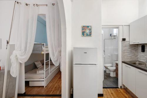 a small kitchen with a bunk bed and a bathroom at Apartment baia del silenzio beach in Sestri Levante