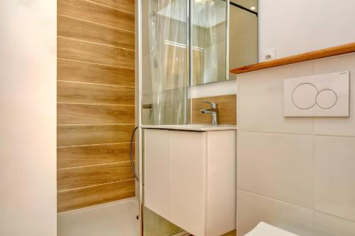a bathroom with white cabinets and a sink at La Dune de Sable - Cavaro in Pornichet