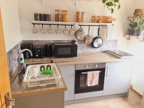 a small kitchen with a sink and a stove at Lush Rooms Bedminster in Bristol