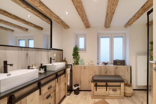 a bathroom with a sink and a large mirror at kernsaniertes Ferienhaus Anna in Durlangen