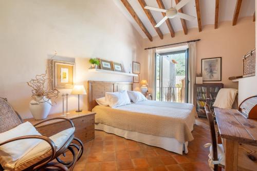 a bedroom with a bed and a table and chairs at Ca Sa Mar in Sóller