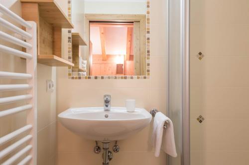 a bathroom with a sink and a mirror at Apartment Bärental - Gruberhof in San Giacomo