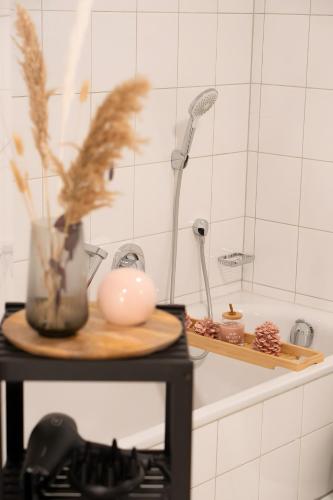 a kitchen with a sink with a shower and a table at Wohnung im Rheintal in Küssaberg