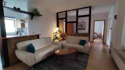 a living room with a couch and a table at Ferienhaus Sonnenschein in Preetz