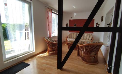 a living room with chairs and a couch and a window at Ferienhaus Sonnenschein in Preetz