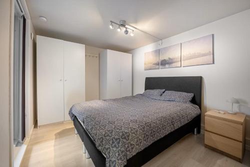 a bedroom with a bed and a dresser in it at Harmony Apartments - Stavanger Sentrum 2 in Stavanger