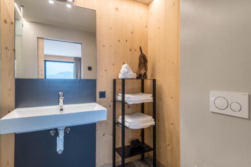 a bathroom with a sink and a mirror at Aumia Apartment Turmalin in Völs am Schlern