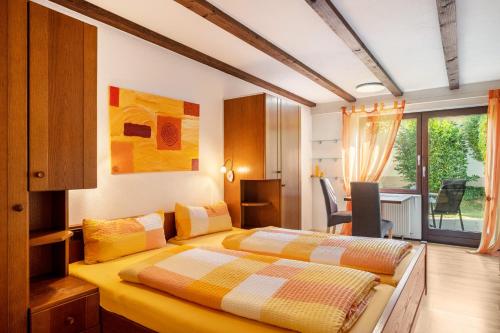 a bedroom with two beds and a dining room with a table at Gästehaus Gaby in Bad Bellingen