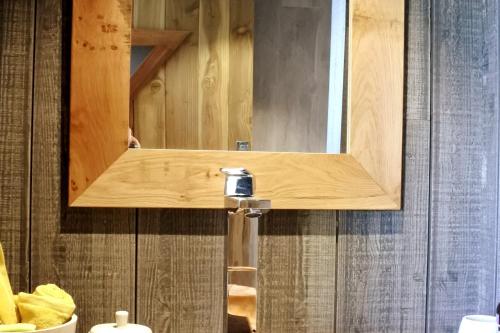 a bathroom with a mirror and a sink at La Cabane Perchée in Vert