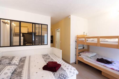 a bedroom with two bunk beds and a window at Chalet Belamy Studio 1 in Courchevel