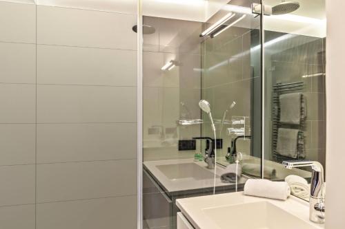 a bathroom with a sink and a glass shower at Haus Excelsior Top 38 in Seefeld in Tirol