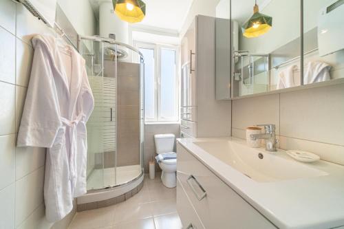 a white bathroom with a sink and a toilet at Contessa di Corfu i in Corfu