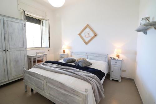 a bedroom with a bed and a desk and a window at Casa Vacanza Primitivo di Manduria in Otranto