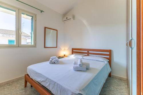 a bedroom with a bed with towels on it at Vista Mare in Santa Croce Camerina