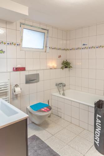 a bathroom with a toilet and a tub and a sink at Ferienwohnung Morgentau in Germersheim