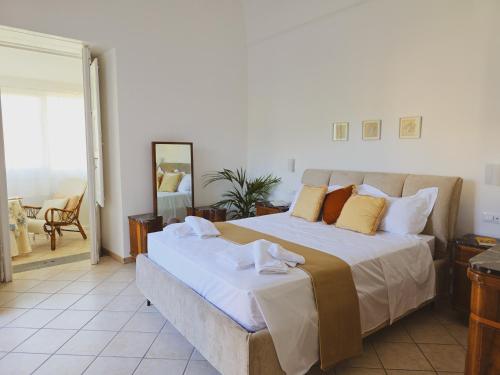 a bedroom with a large bed with yellow pillows at Syrenia Home in Vico Equense