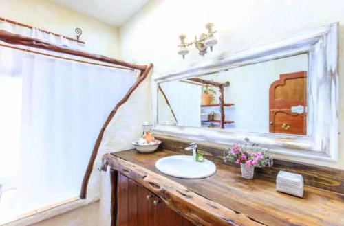 a bathroom with a sink and a mirror at Can Picca in Illes Balears
