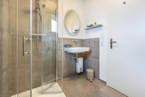 a bathroom with a sink and a shower at Egge Resort 7c mit Whirpool u Sauna in Altenbeken