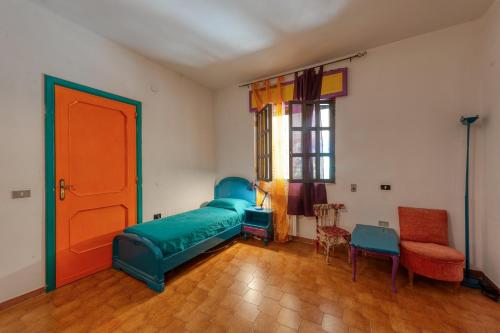 a room with a bed and chairs and a door at Sprocketlandia in Frigole