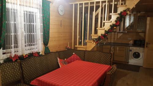a room with a table with a red table cloth at Dolina Skawy in Skawa