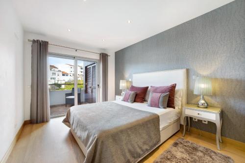 a bedroom with a large bed and a large window at Tourismer C in Lagos