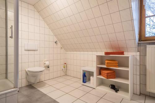a white bathroom with a toilet and a shower at Ferienwohnung Nr 2 in Deggenhausertal