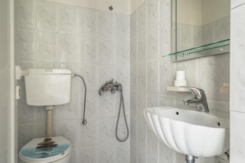 a bathroom with a sink and a toilet at Angela partial sea view 8 in Kefallonia
