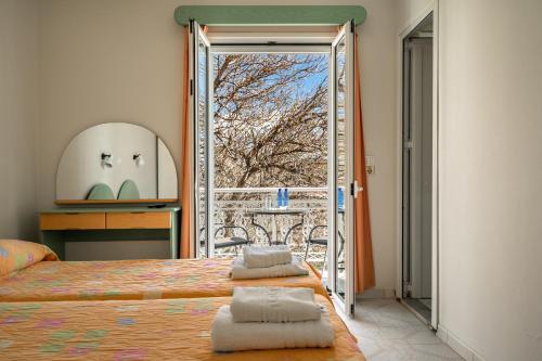 a bedroom with a bed and a large window at Angela partial sea view 8 in Kefallonia